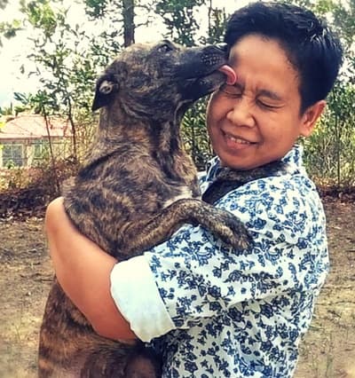 Jazi hugging his dog Jersey