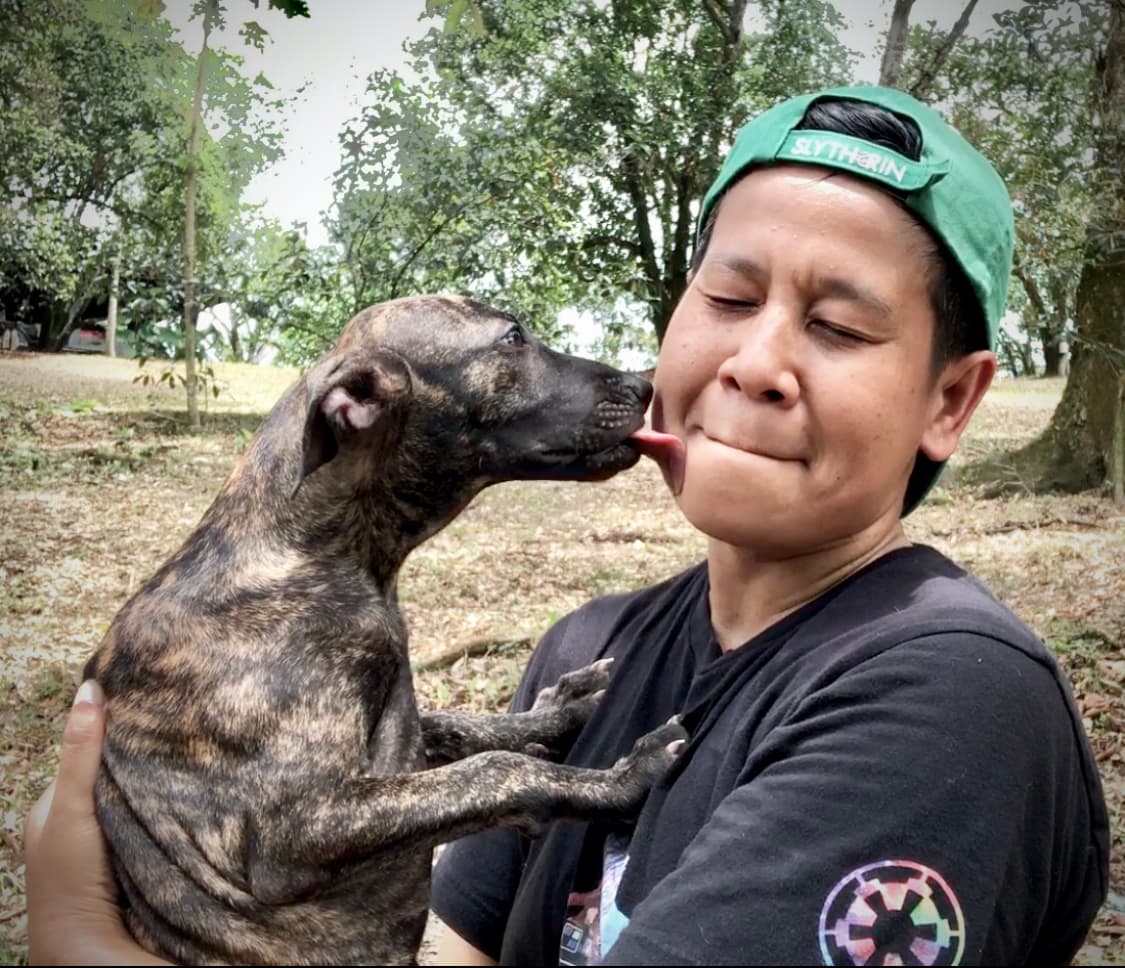 Jazi holding his new puppy, the manifested miracle