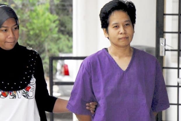 Jazi handcuffed wearing purple jail uniform